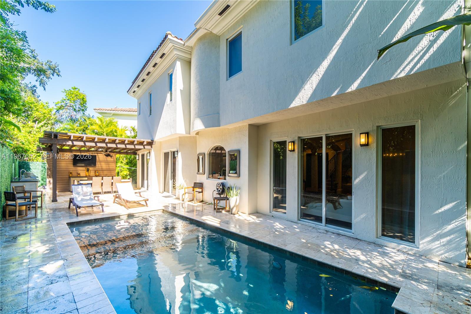 A two-story house exterior features a swimming pool, patio, and a wooden pergola — 2752 Brickell Ct, Miami FL 33129, MIAMI, FL