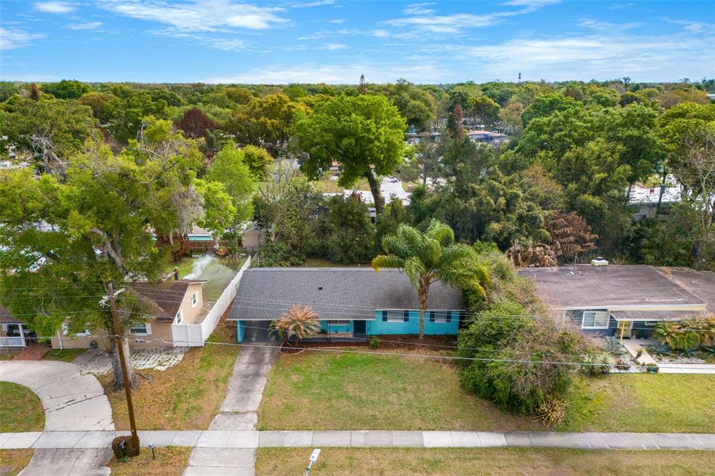 An aerial view shows a teal single-story house with a driveway and a front yard — 2923 CONWAY GARDENS ROAD, ORLANDO, FL