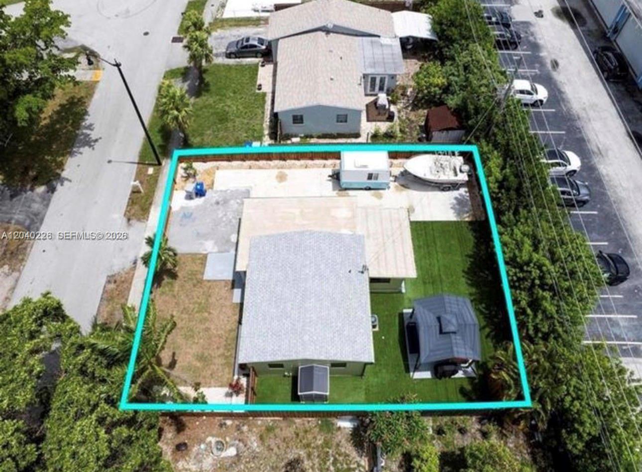 An aerial view shows a house with a fenced yard, a boat, and a trailer — 2730 NE 16th ave, Pompano Beach FL 33064, POMPANO BEACH, FL
