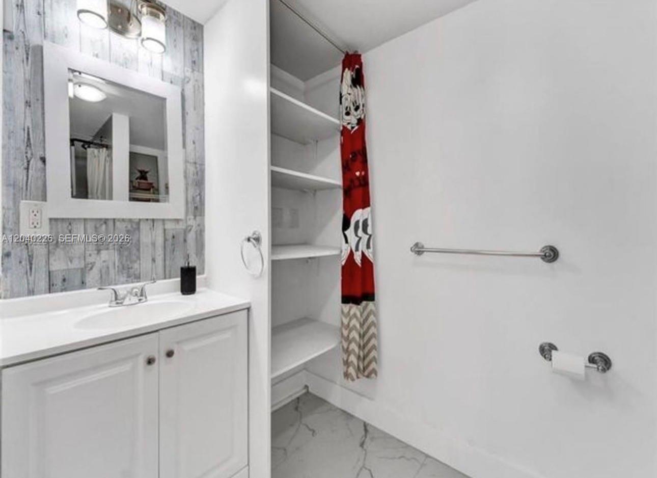 A bathroom features a white vanity, open shelving, a mirror, and a red patterned curtain — 2730 NE 16th ave, Pompano Beach FL 33064, POMPANO BEACH, FL