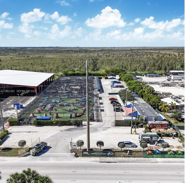An aerial view shows a paintball facility with a netted field, parking, and small buildings — 220 NW 137th Ave, Miami FL 33182, MIAMI, FL