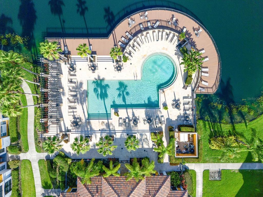 An aerial view of a swimming pool and deck area surrounded by palm trees — 8377 38TH STREET CIRCLE E UNIT 106, SARASOTA, FL
