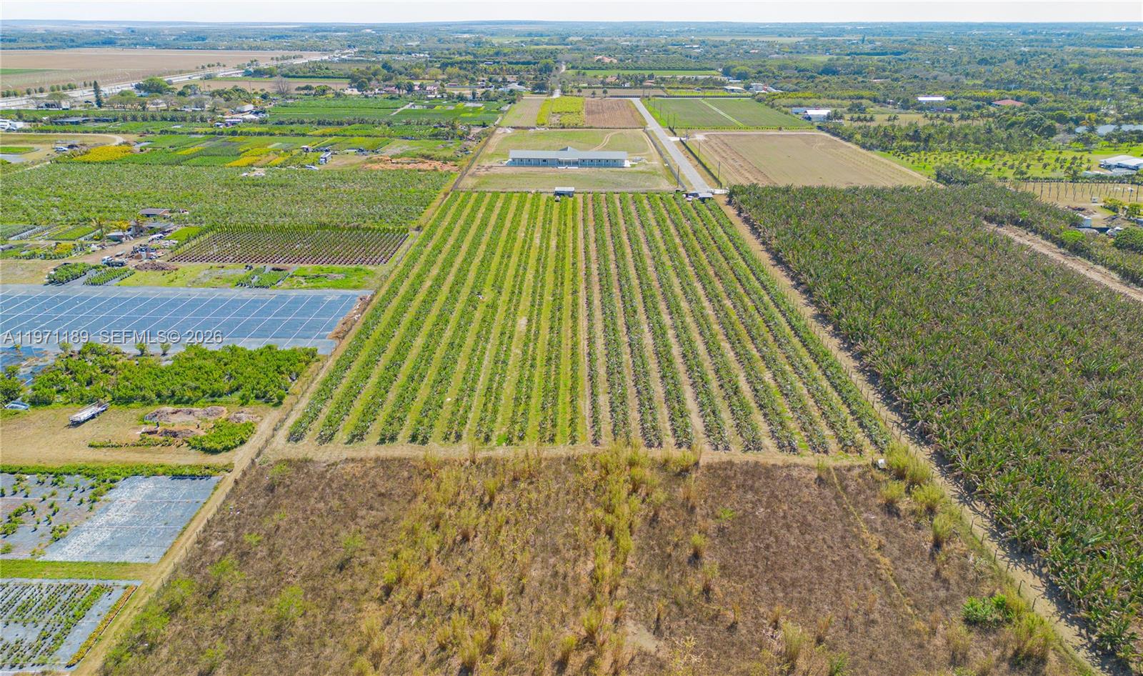 An aerial view shows a large agricultural property with crop rows, fields, and a building — 139XX sw 180TH AVE, Miami FL 33196, MIAMI, FL