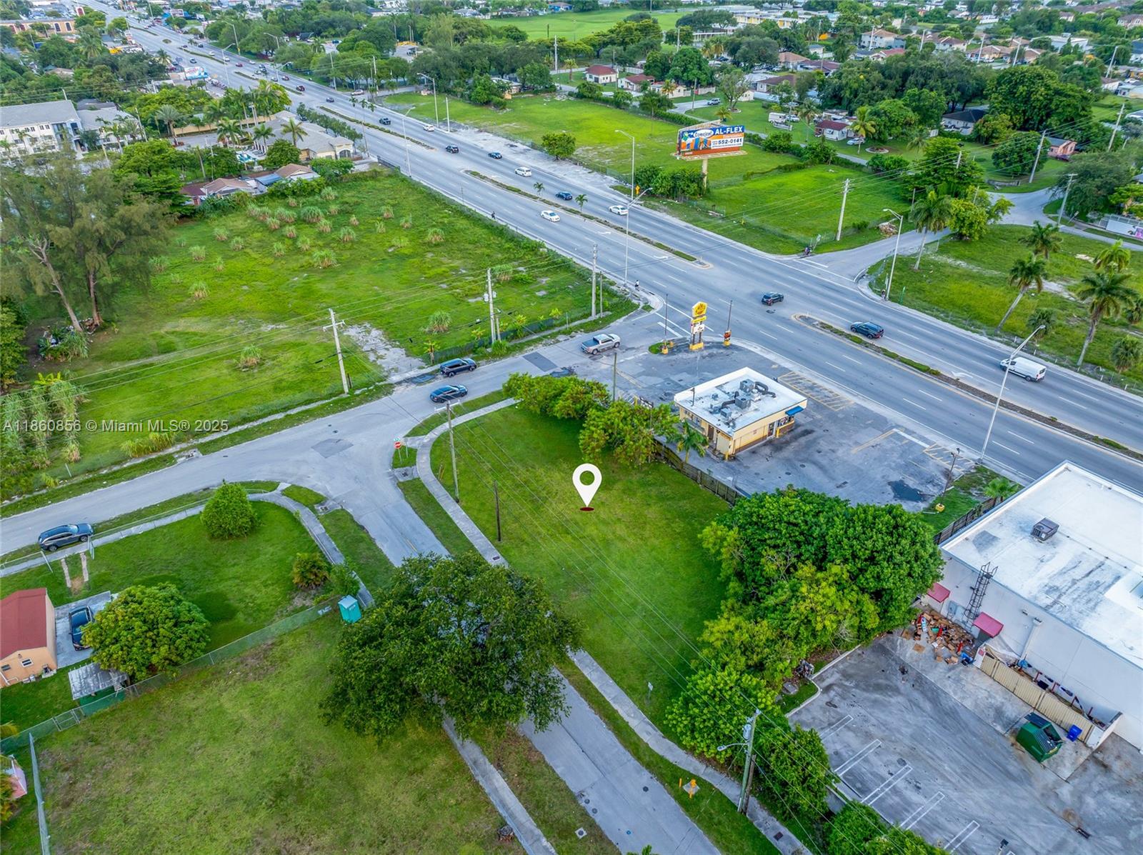 An aerial view shows a vacant grassy lot next to a commercial building and road — 21 ave, Miami FL 33147, MIAMI, FL