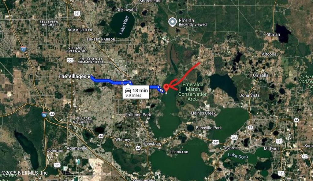 This is a map showing a driving route from The Villages to Emeralda Marsh Conservation Area — 6001 BIRD ISLAND DRIVE, LADY LAKE, FL