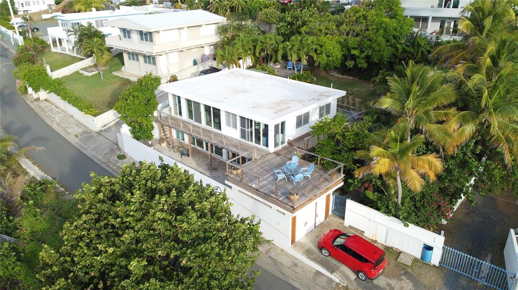 An aerial view of a two-story house with a rooftop deck and a red car — 56 N SHORE ROAD, VIEQUES, PR
