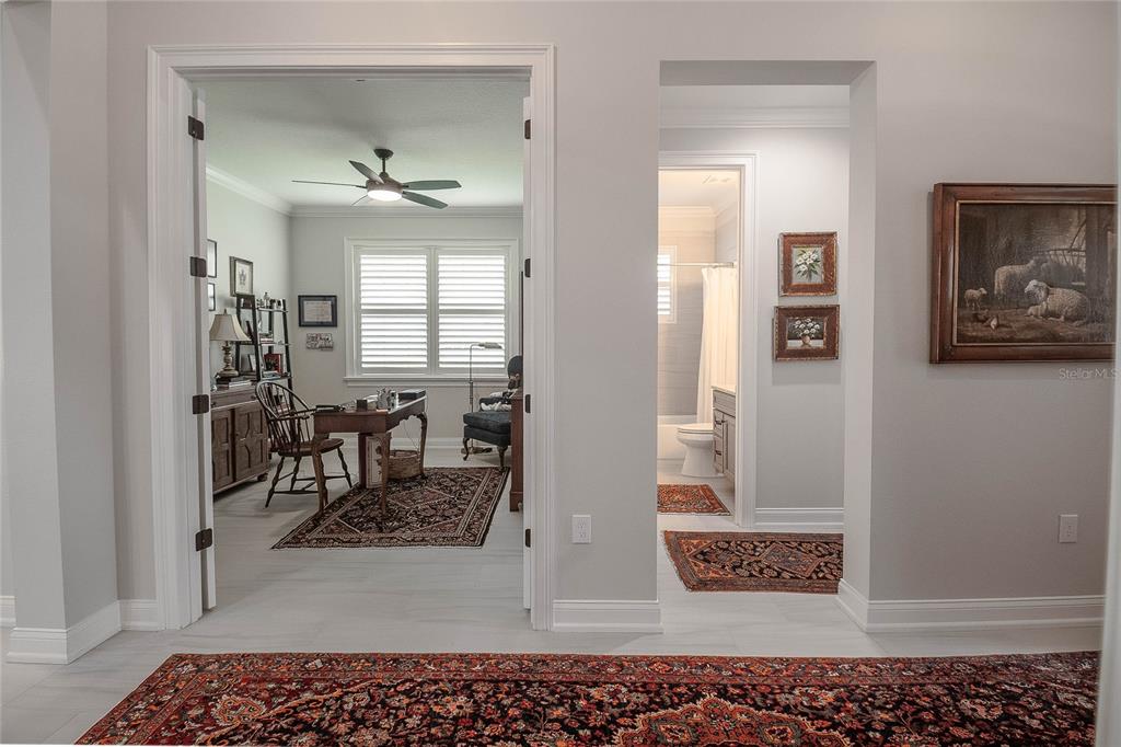 A view through a doorway into a home office and a hallway with a bathroom — 7914 LAKE JAMES BOULEVARD, LAKELAND, FL
