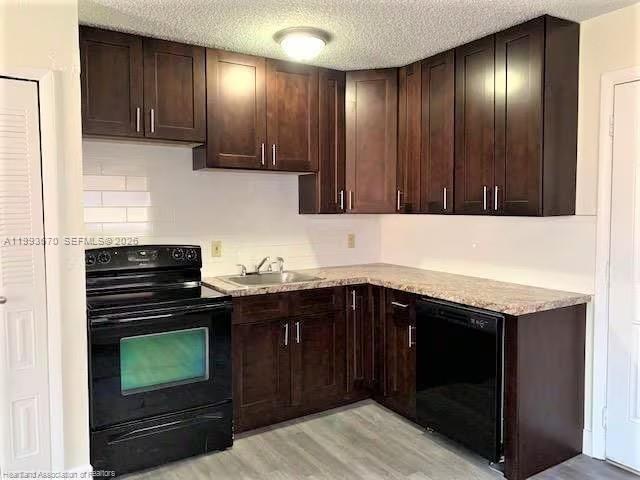 A kitchen features dark wood cabinets, black appliances, and a light-colored countertop — 425 Las Palmas # 612, Avon Park FL 33825, AVON PARK, FL