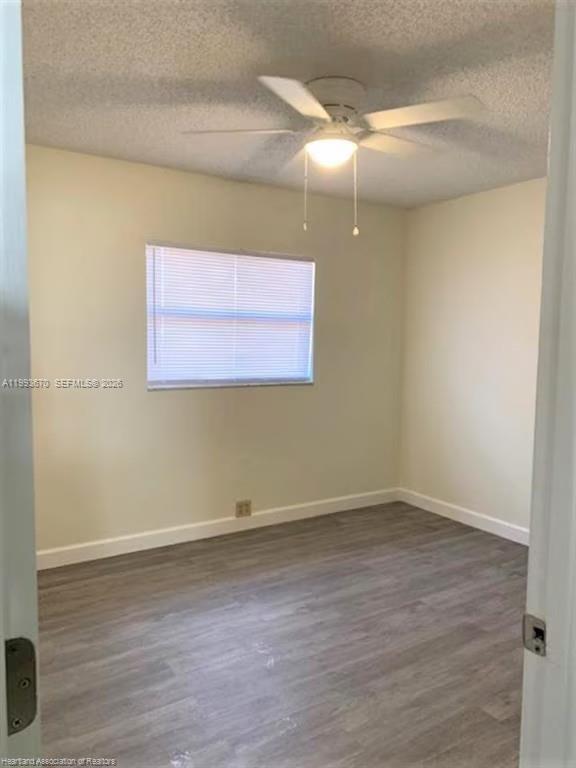 An empty bedroom with light-colored walls, a ceiling fan, and grey wood-look flooring — 425 Las Palmas # 612, Avon Park FL 33825, AVON PARK, FL