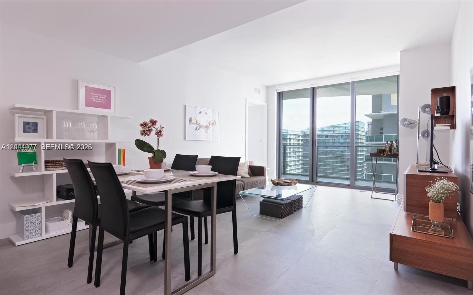 A modern dining and living area features white walls, tile floors, and floor-to-ceiling windows — 1300 S Miami Ave # 3311, Miami FL 33130, MIAMI, FL