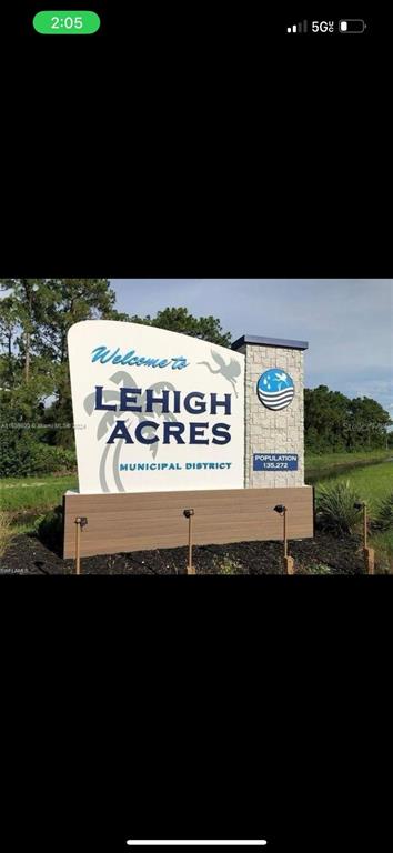 A sign welcomes visitors to the Lehigh Acres municipal district with a population count displayed — 3117 51ST STREET W, LEHIGH ACRES, FL