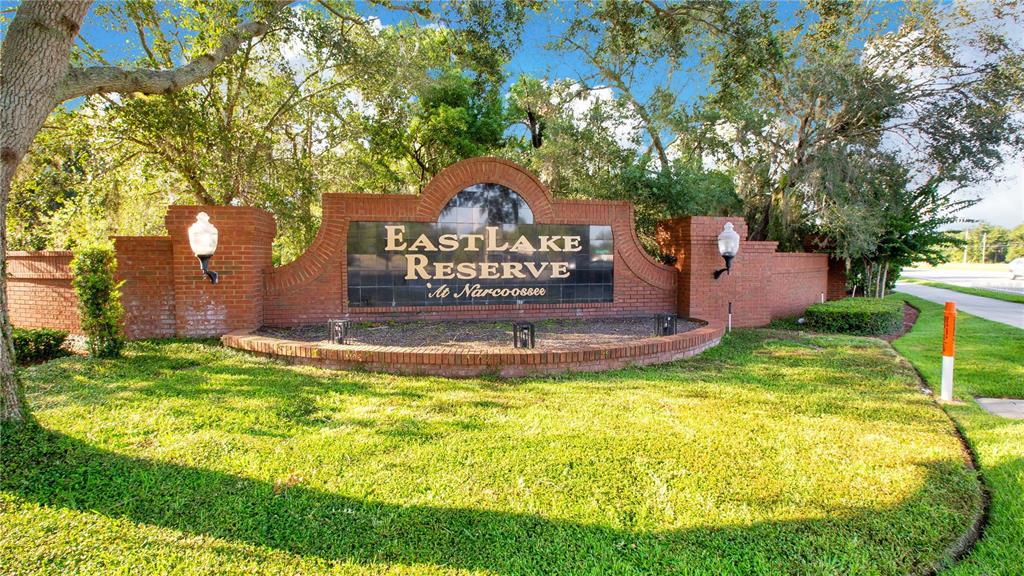 A brick entrance sign for Eastlake Reserve at Narcoossee stands in a grassy landscape — 4924 RAYLENE WAY, ST CLOUD, FL