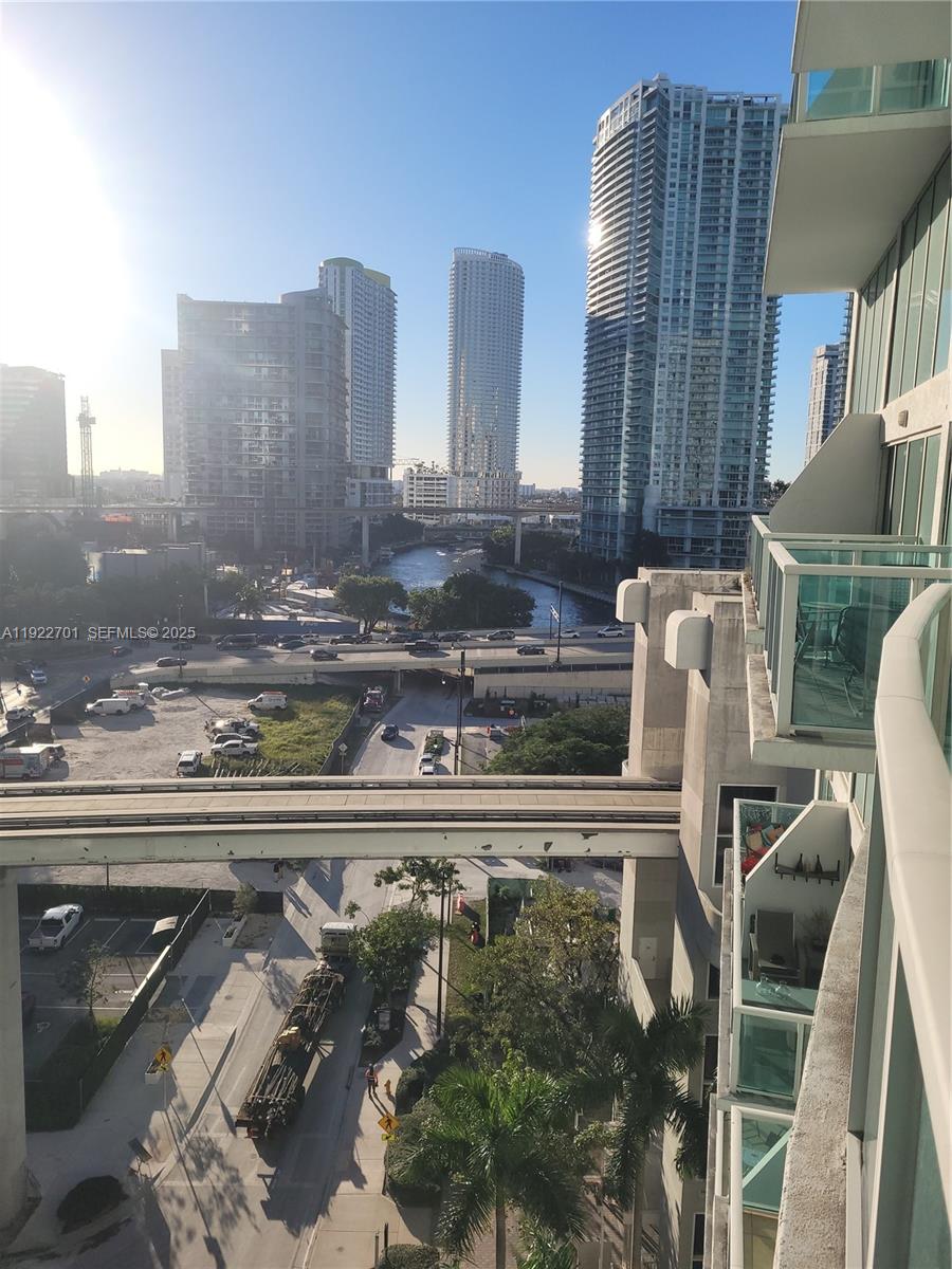 An elevated view shows a city skyline, a river, a highway, and a monorail track — 41 SE 5th St # 710, Miami FL 33131, MIAMI, FL