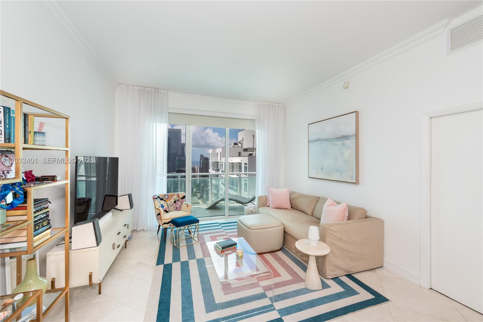 A living room features a patterned rug, a beige sofa, and a balcony with city views — 950 Brickell Bay Dr # 4403, Miami FL 33131, MIAMI, FL