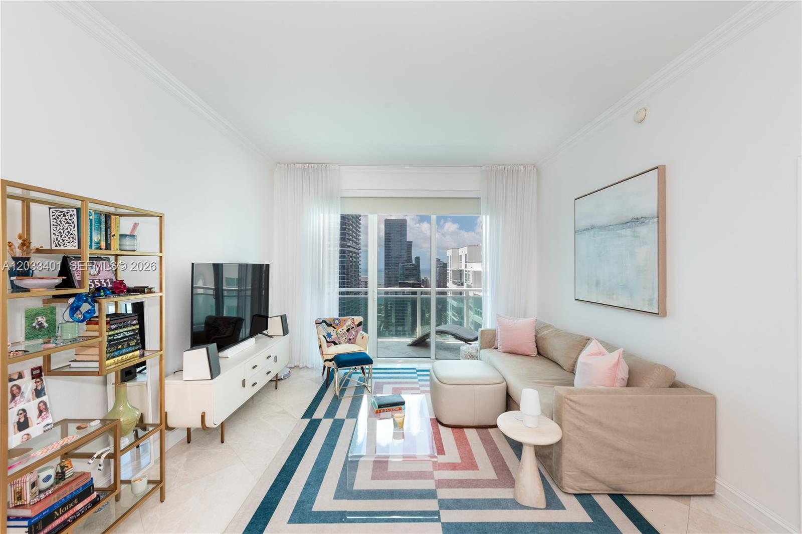 A living room features a beige sectional sofa, a geometric rug, and a city view — 950 Brickell Bay Dr # 4403, Miami FL 33131, MIAMI, FL
