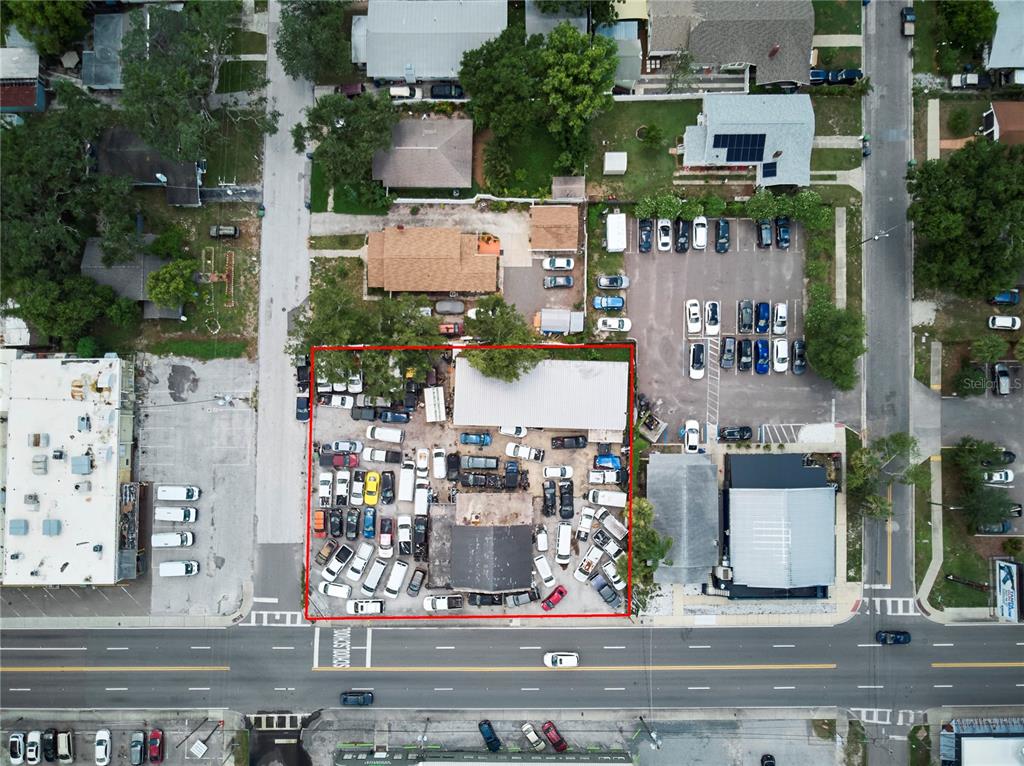 An aerial view shows a commercial property with a crowded parking lot and two buildings — 6304 N FLORIDA AVENUE, TAMPA, FL