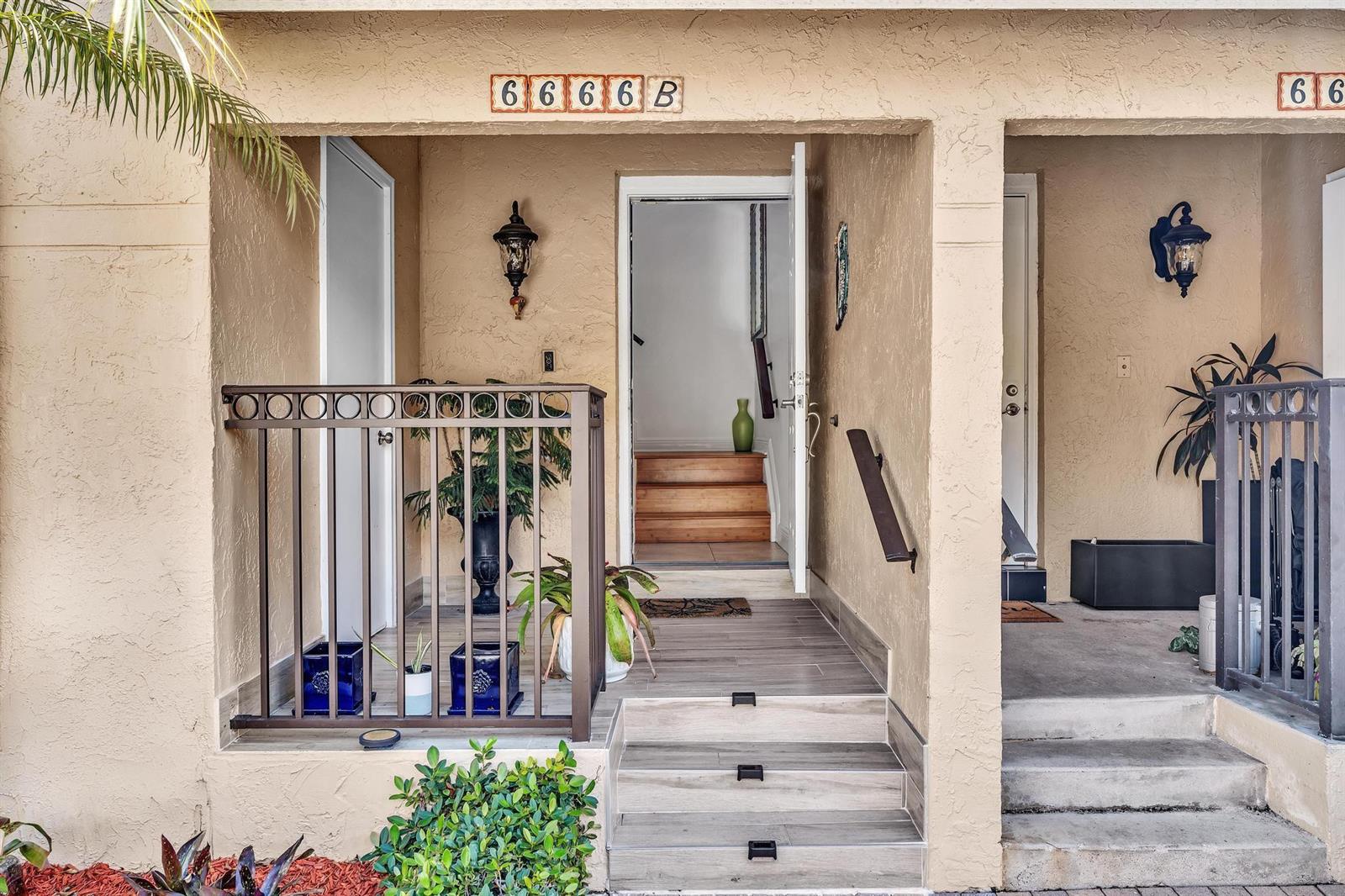 The exterior entrance features tiled steps, a metal railing, and a doorway leading to stairs — 6666 Montego Bay Boulevard # B, Boca Raton FL 33433, BOCA RATON, FL