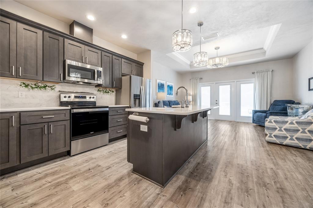 A kitchen with dark gray cabinets, stainless steel appliances, and a central island — 12945 NW 12 ROAD, NEWBERRY, FL