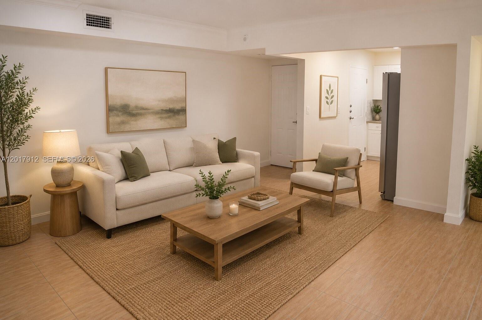 A living room features a beige sofa, wooden coffee table, armchair, and light-colored tile flooring — 9429 SW 76th St # W25, Miami FL 33173, MIAMI, FL