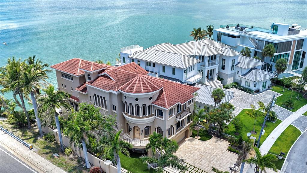 An aerial view of two large waterfront houses with tiled roofs and landscaped yards — 290 N WASHINGTON DRIVE, SARASOTA, FL