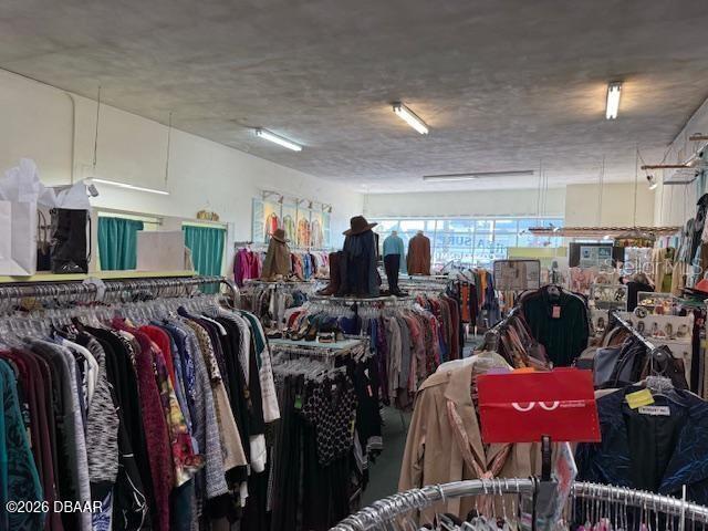 A clothing store interior features racks of apparel, mannequins, and fluorescent lighting — 0 CONFIDENTIAL, ORMOND BEACH, FL