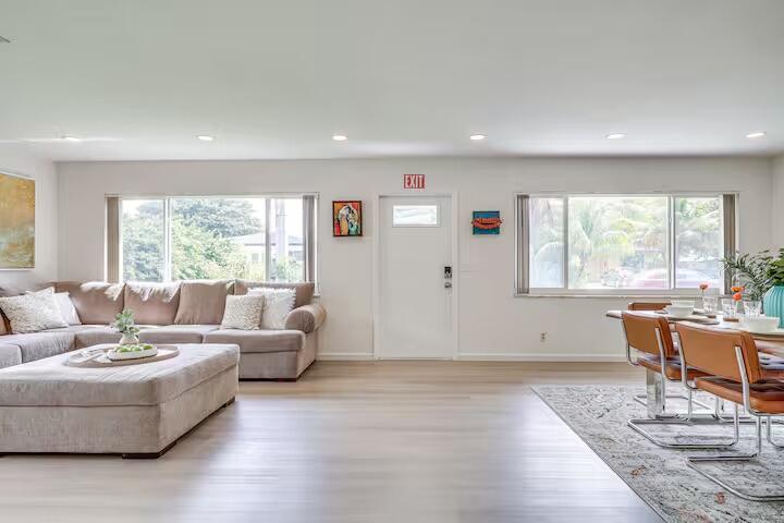A living and dining area features light wood floors, a beige sectional, and a white door — 124 SW 2nd Avenue, Hallandale Beach FL 33009, HALLANDALE BEACH, FL