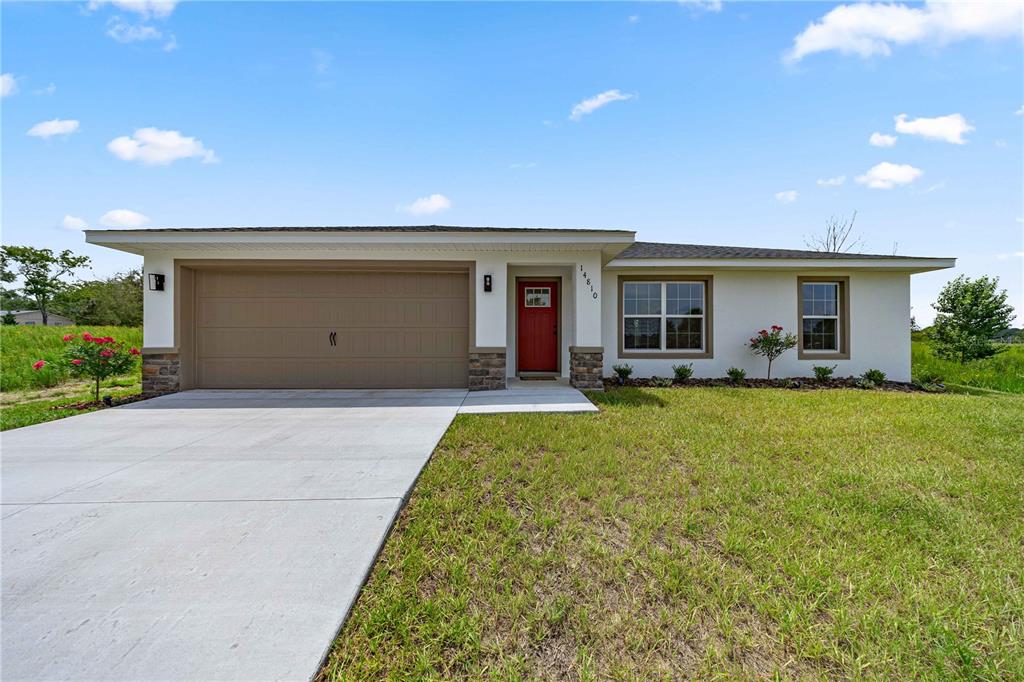This open-concept living and dining area features light wood flooring, neutral furniture, and recessed lighting — 14810 SW 33RD LANE, OCALA, FL