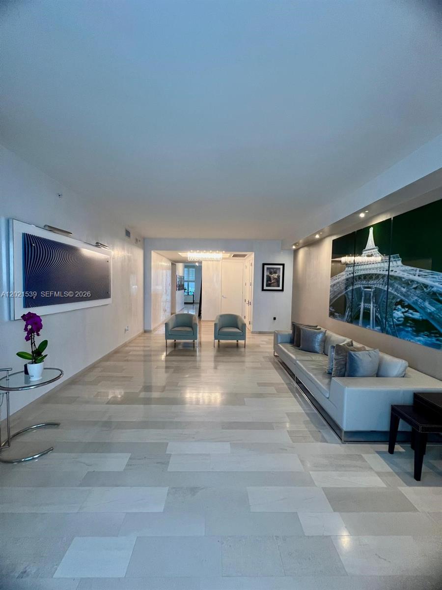 A living room features light wood floors, a leather sofa, two armchairs, and floor-to-ceiling windows — 1300 E Brickell Bay Dr # 3701, Miami FL 33131, MIAMI, FL