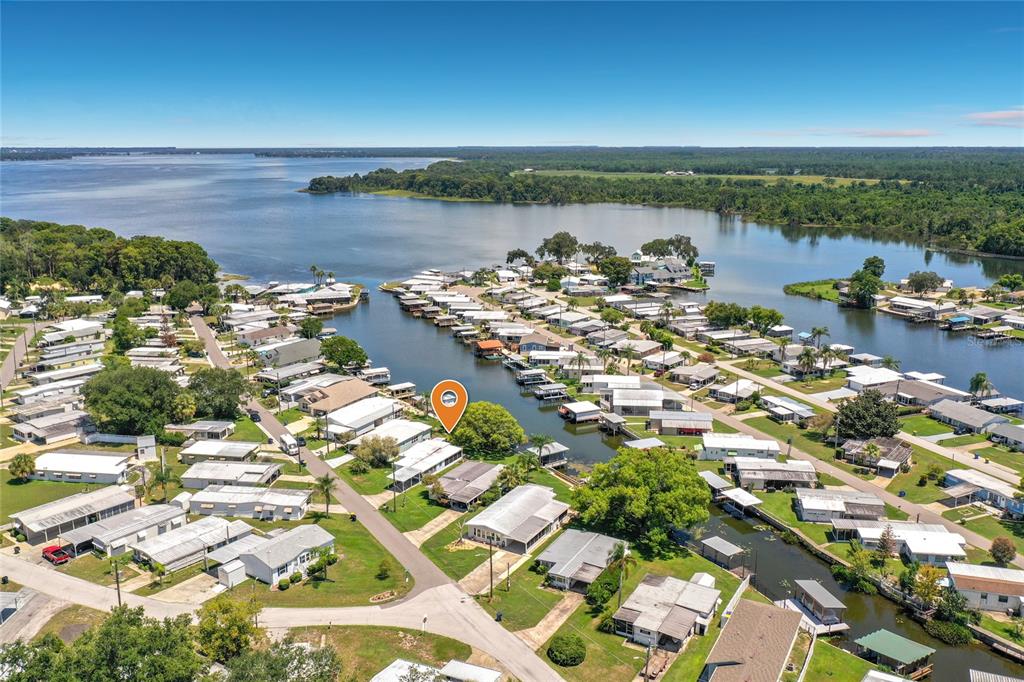 An aerial view shows a waterfront mobile home community with a marked property — 1521 LAKEVIEW DRIVE, TAVARES, FL