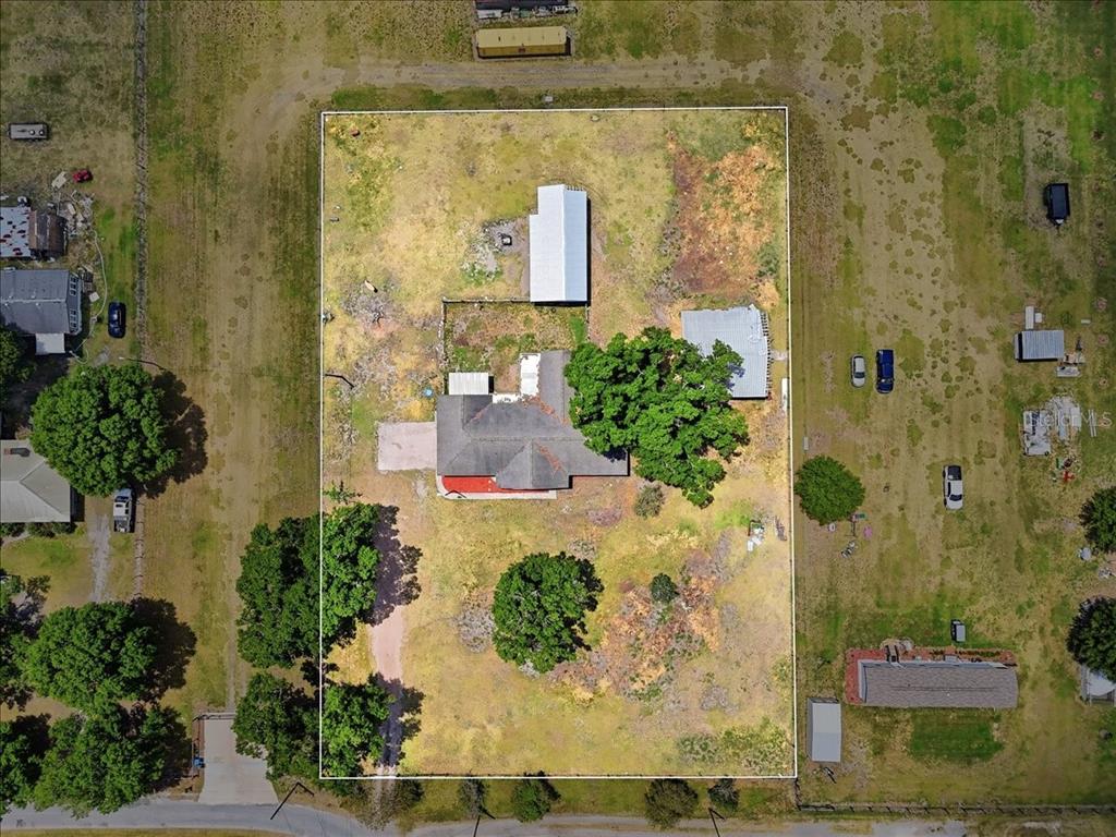 An aerial view shows a house with a large tree on a rectangular fenced lot — 303 KARPPE ROAD, PLANT CITY, FL