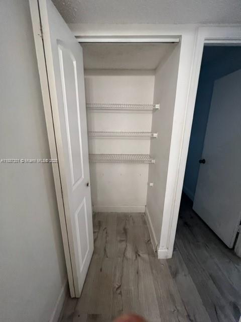 A closet with three wire shelves and light wood-look flooring — 7001 Environ Blvd # 308, Lauderhill FL 33319, LAUDERHILL, FL