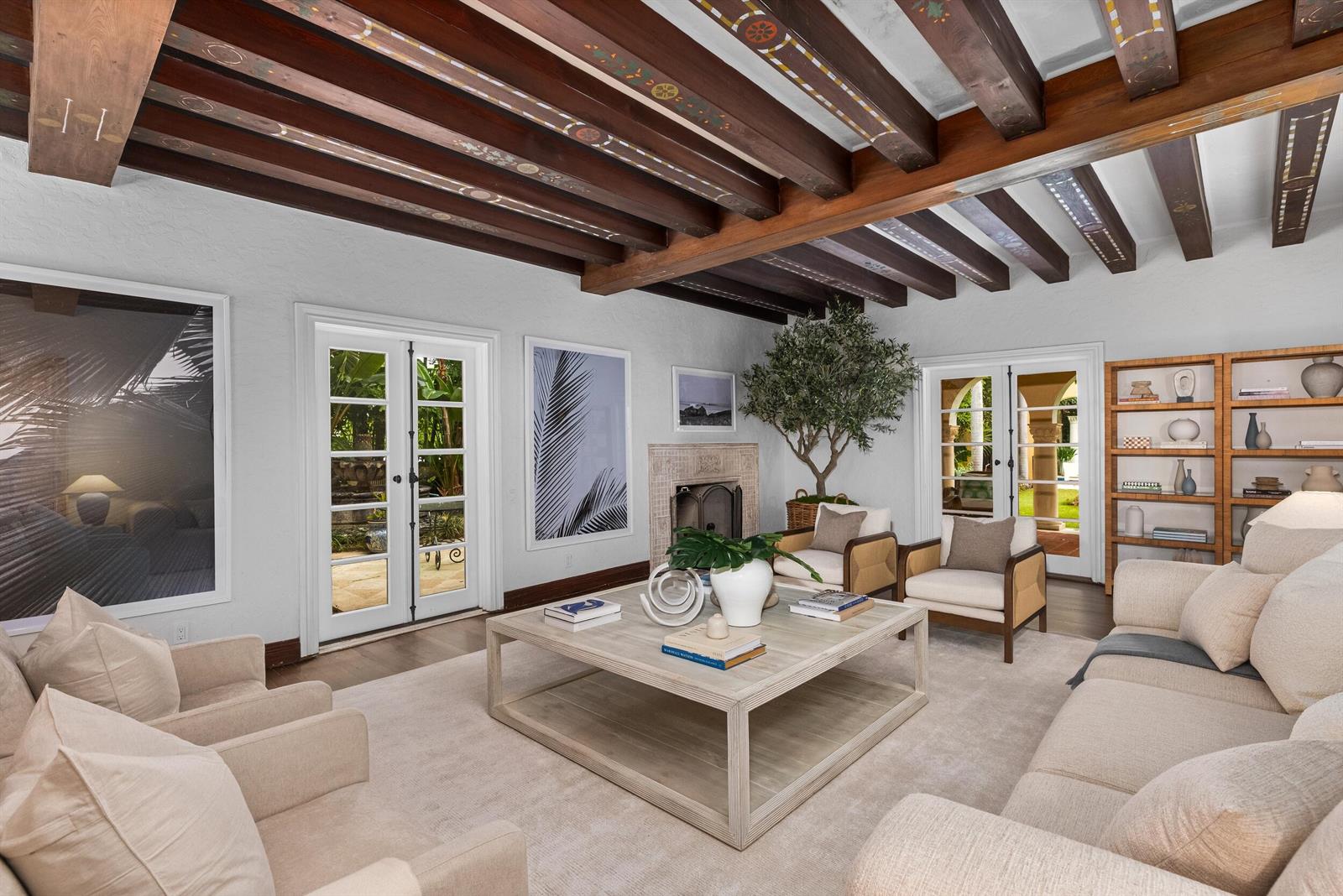 A living room features exposed painted ceiling beams, a large coffee table, and French doors — 124 Brazilian Avenue, Palm Beach FL 33480, PALM BEACH, FL