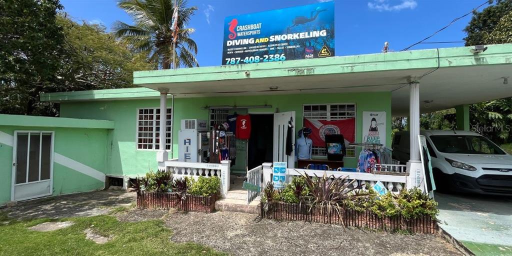 A light green building with a diving and snorkeling shop sign stands outdoors — CARR NÚM. 458 KM 1.5 BO MUNICIPIO, AGUADILLA, PR
