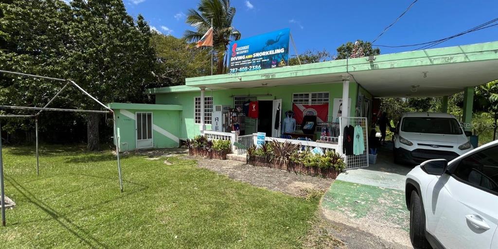 A light green building with a diving and snorkeling sign sits on a grassy lot — CARR NÚM. 458 KM 1.5 BO MUNICIPIO, AGUADILLA, PR