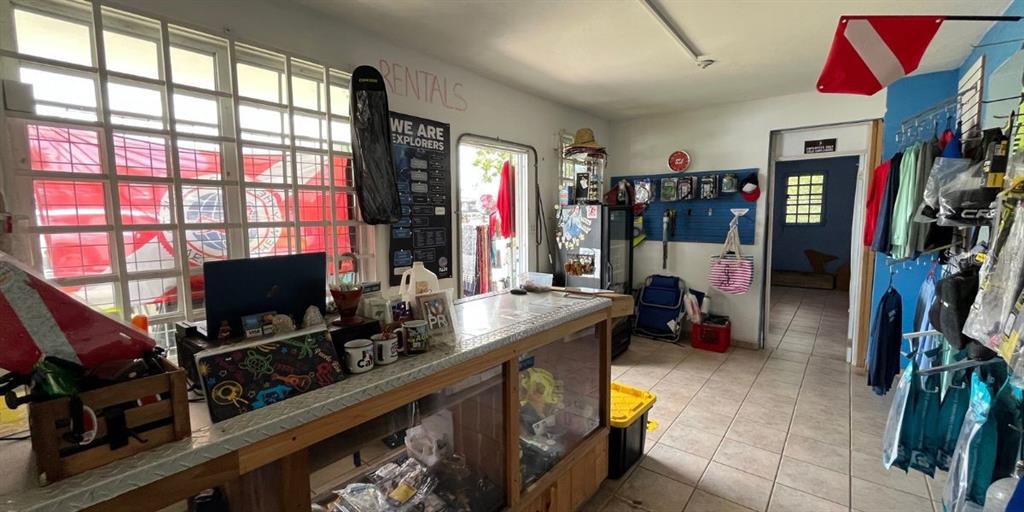 A retail shop interior features a service counter, merchandise displays, and tiled flooring — CARR NÚM. 458 KM 1.5 BO MUNICIPIO, AGUADILLA, PR