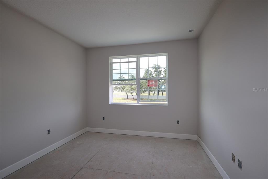 A kitchen under construction features light gray cabinets, white countertops, and a herringbone tile backsplash — 3539 WOLVES CREEK PLACE, APOPKA, FL