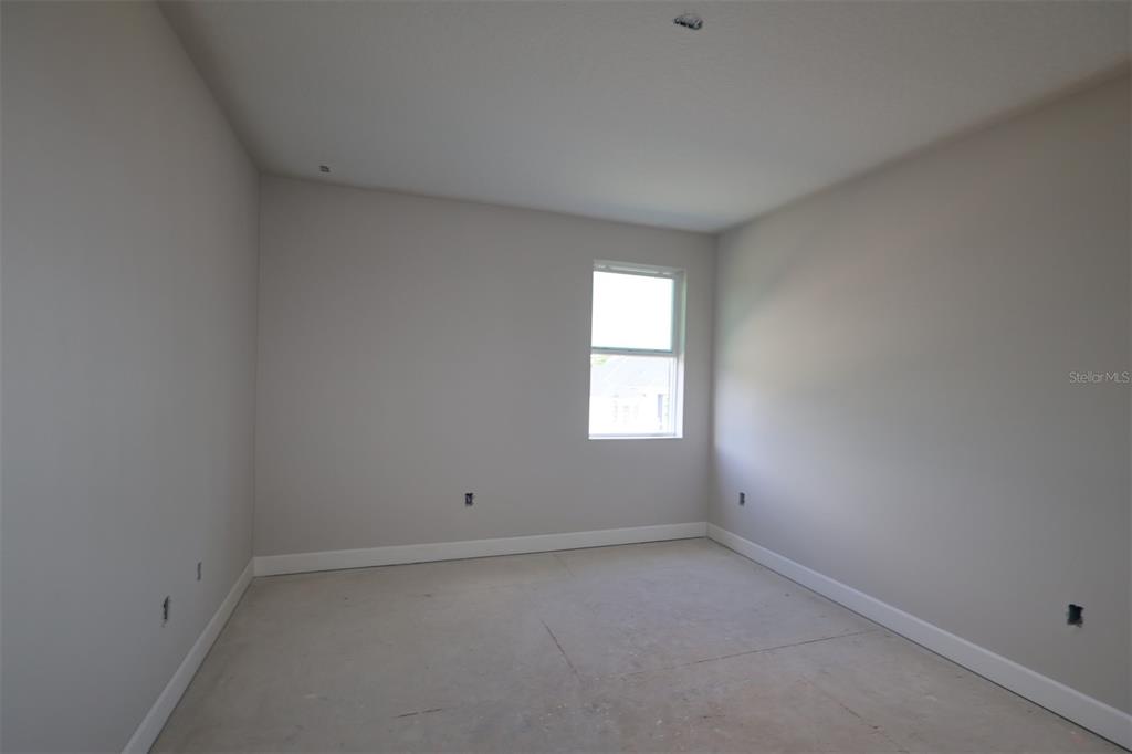 A bathroom features dual vanities with white countertops, a large mirror, and a soaking tub — 3539 WOLVES CREEK PLACE, APOPKA, FL