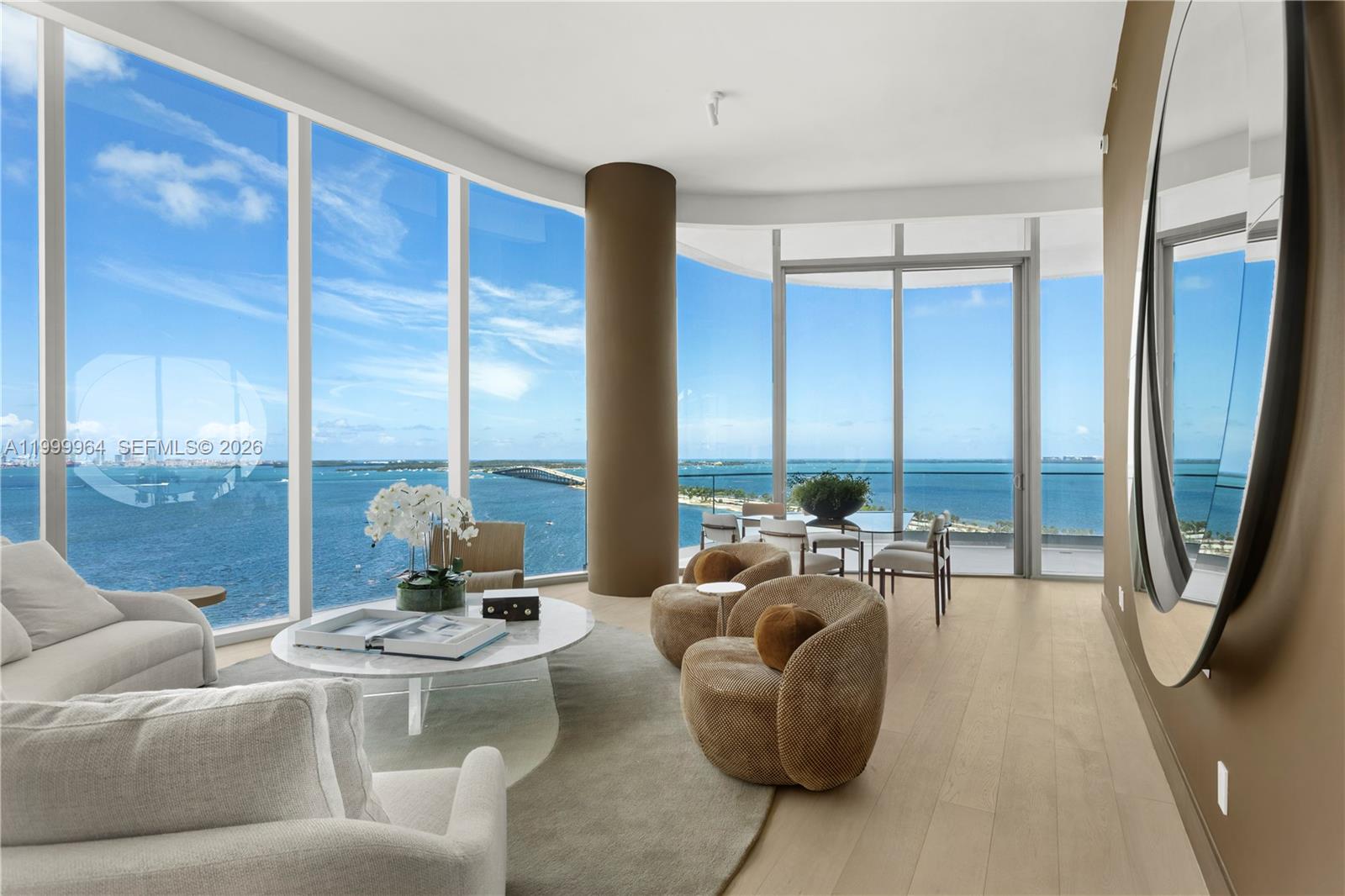 A modern living room features floor-to-ceiling windows with expansive ocean and bridge views — 175 SE 25th Rd # 1501, Miami FL 33129, MIAMI, FL