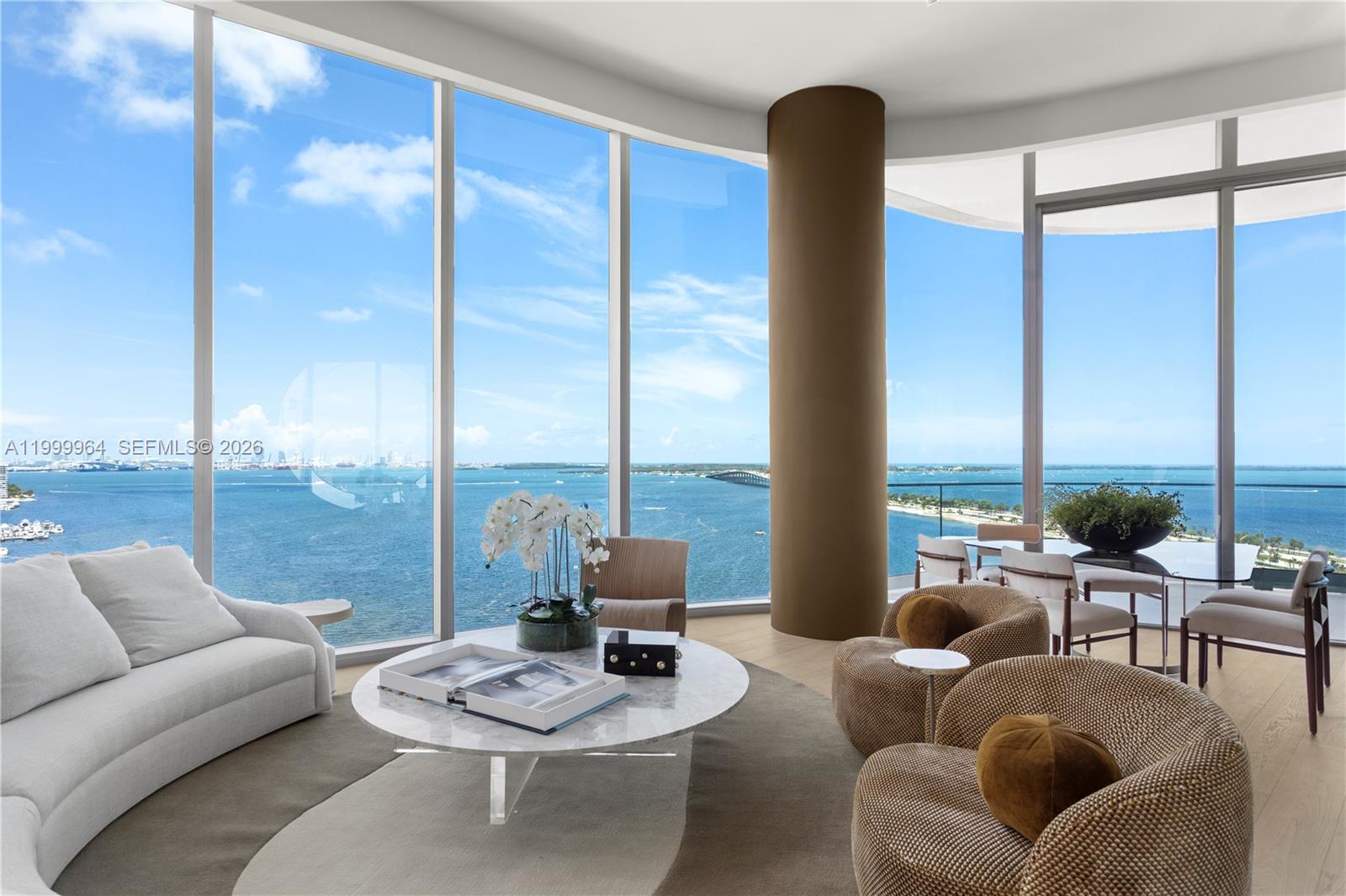 A modern living room features floor-to-ceiling windows with panoramic ocean and bridge views — 175 SE 25th Rd # 1501, Miami FL 33129, MIAMI, FL