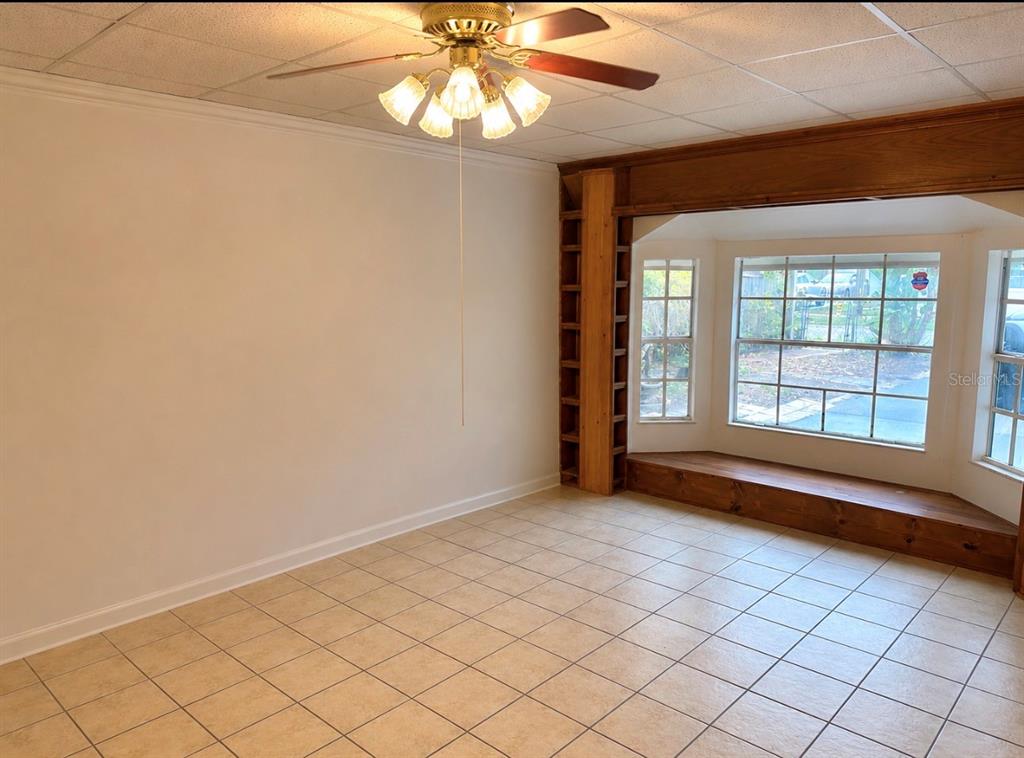 A room with tiled floors, a ceiling fan, and a wooden bay window seat — 1406 MURILLO LOOP, RUSKIN, FL