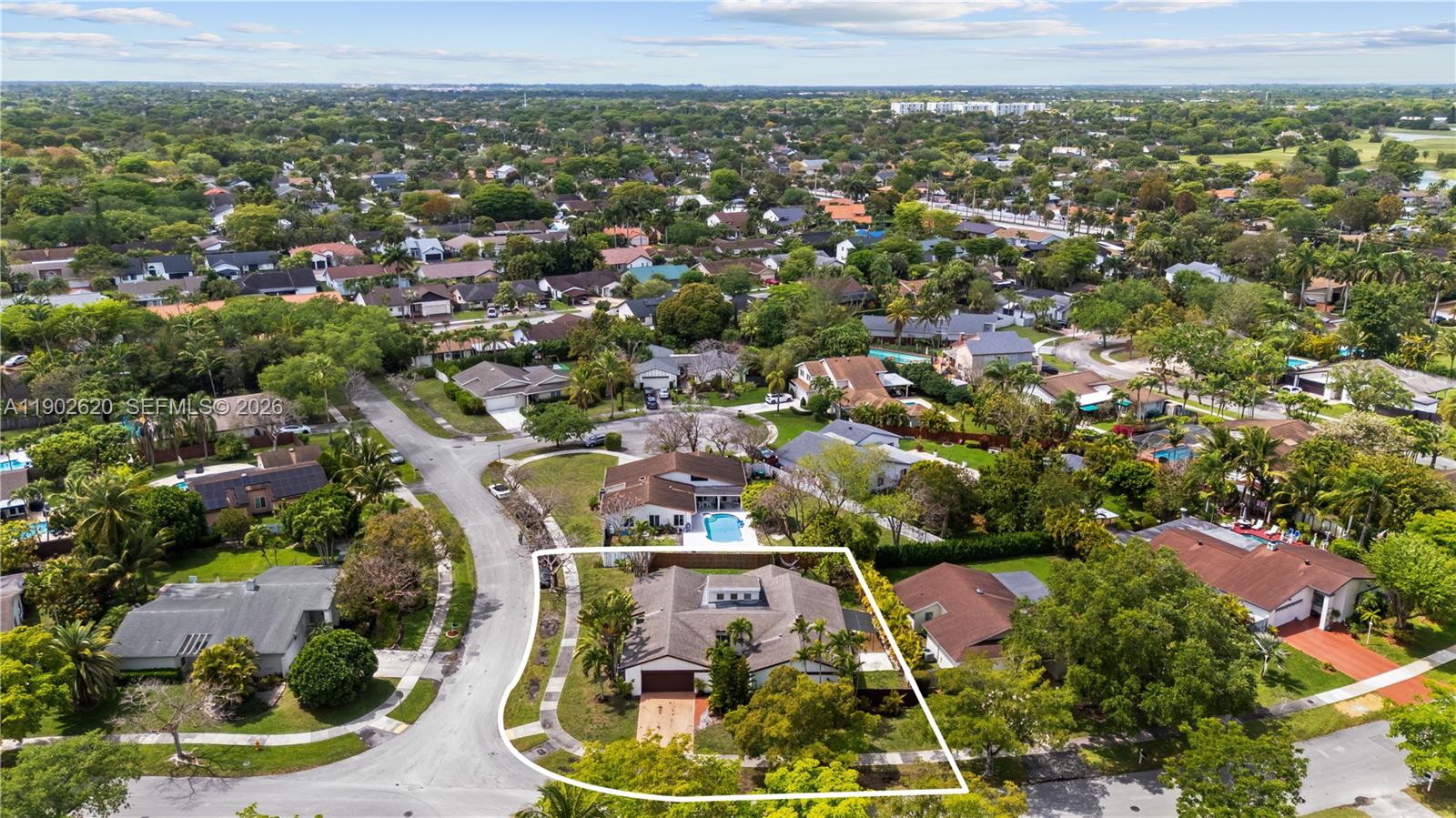 An aerial view shows a single-story house with a brown roof and a corner lot — 10610 SW 128th Ave, Miami FL 33186, MIAMI, FL