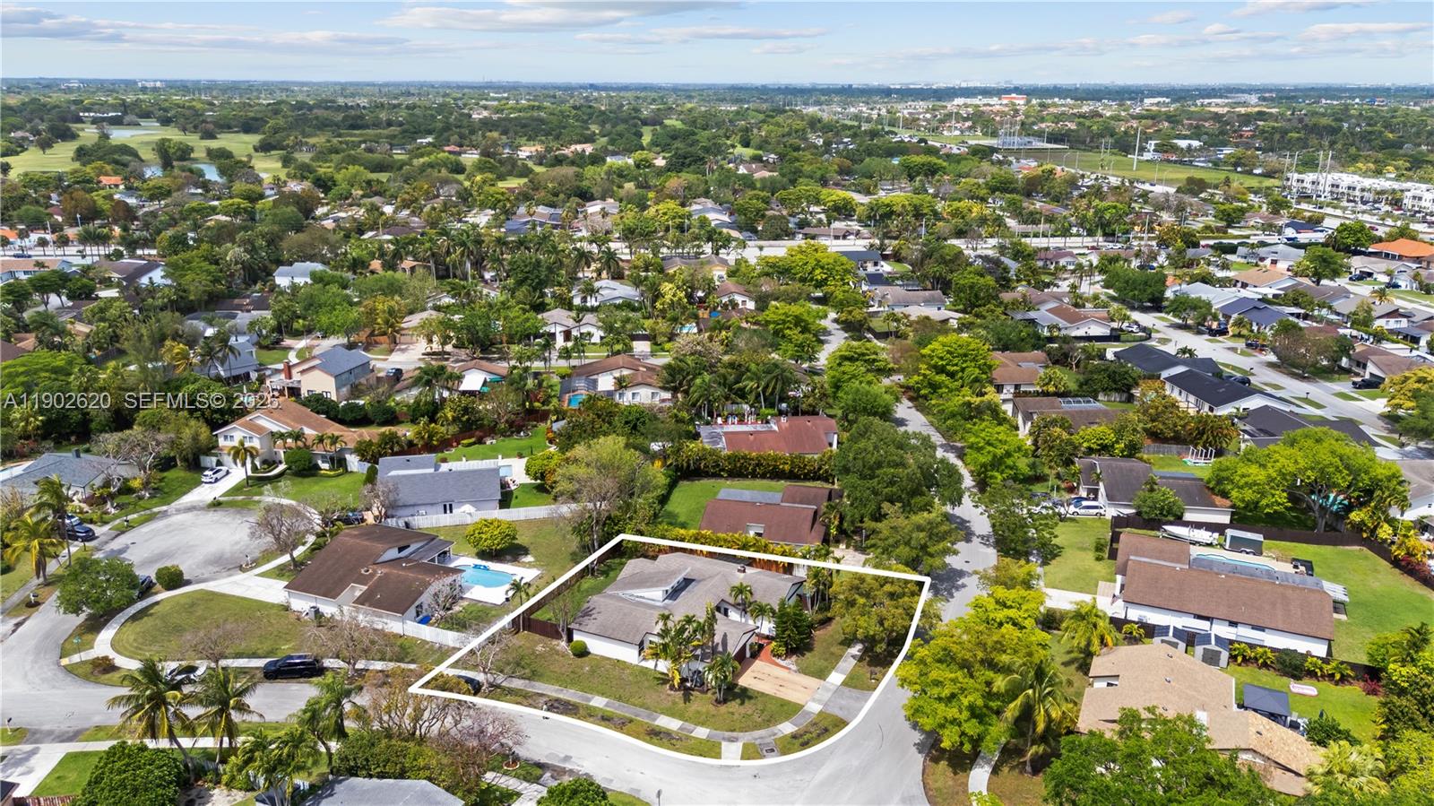 An aerial view shows a single-story house with a white outline on a corner lot — 10610 SW 128th Ave, Miami FL 33186, MIAMI, FL