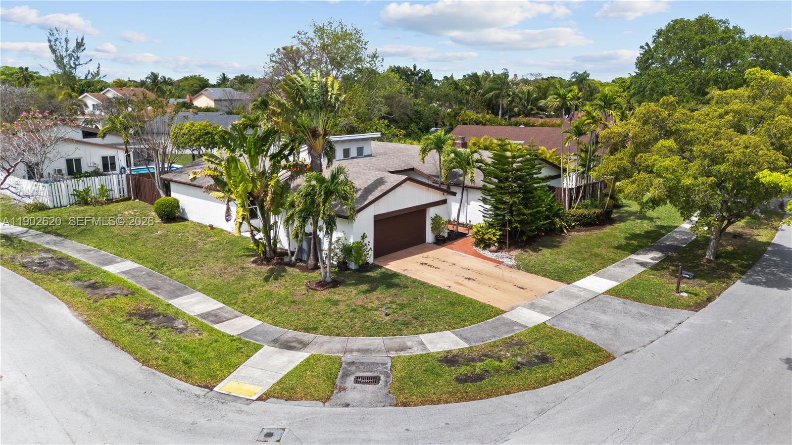 An aerial view shows a single-story house with a brown garage and palm trees — 10610 SW 128th Ave, Miami FL 33186, MIAMI, FL