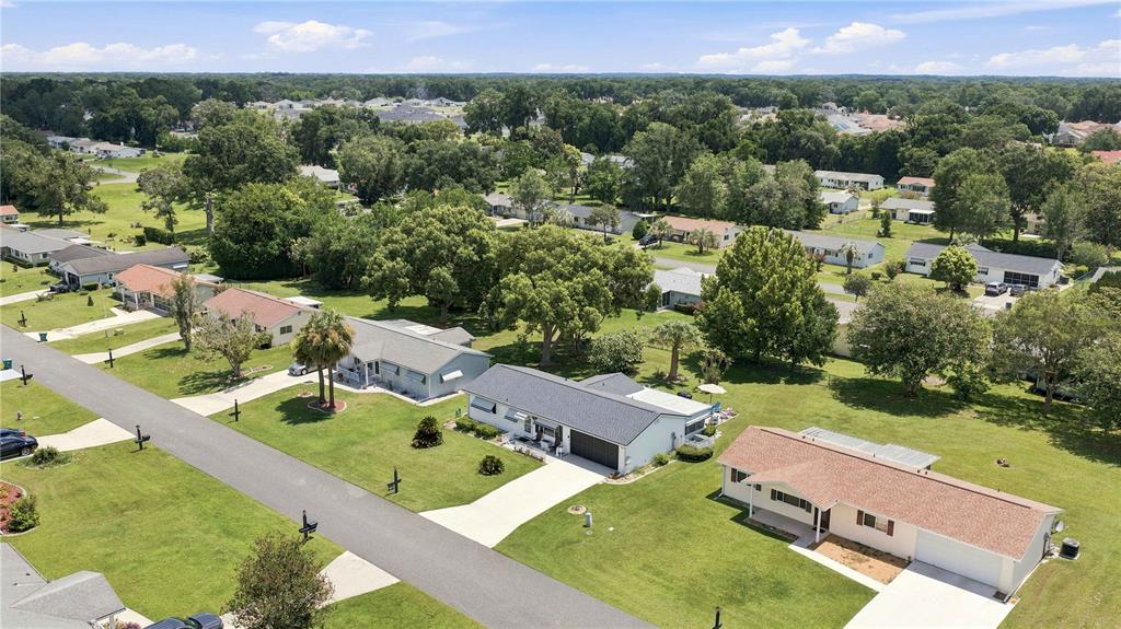 An aerial view shows several single-story residential houses with driveways and lawns in a neighborhood — 11151 SW 76TH AVENUE, OCALA, FL