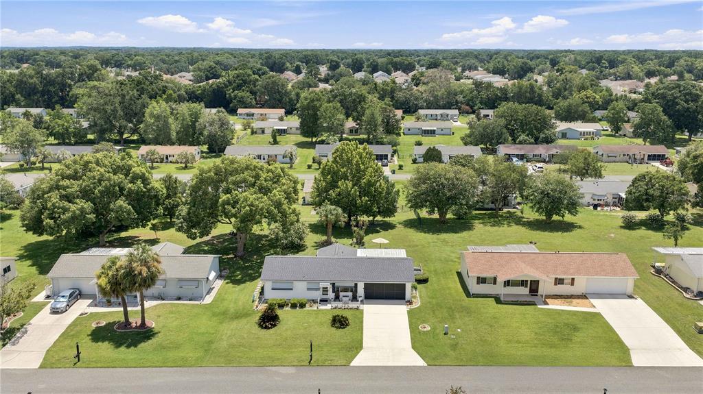 An aerial view of a suburban neighborhood featuring single-story houses with driveways and green lawns — 11151 SW 76TH AVENUE, OCALA, FL
