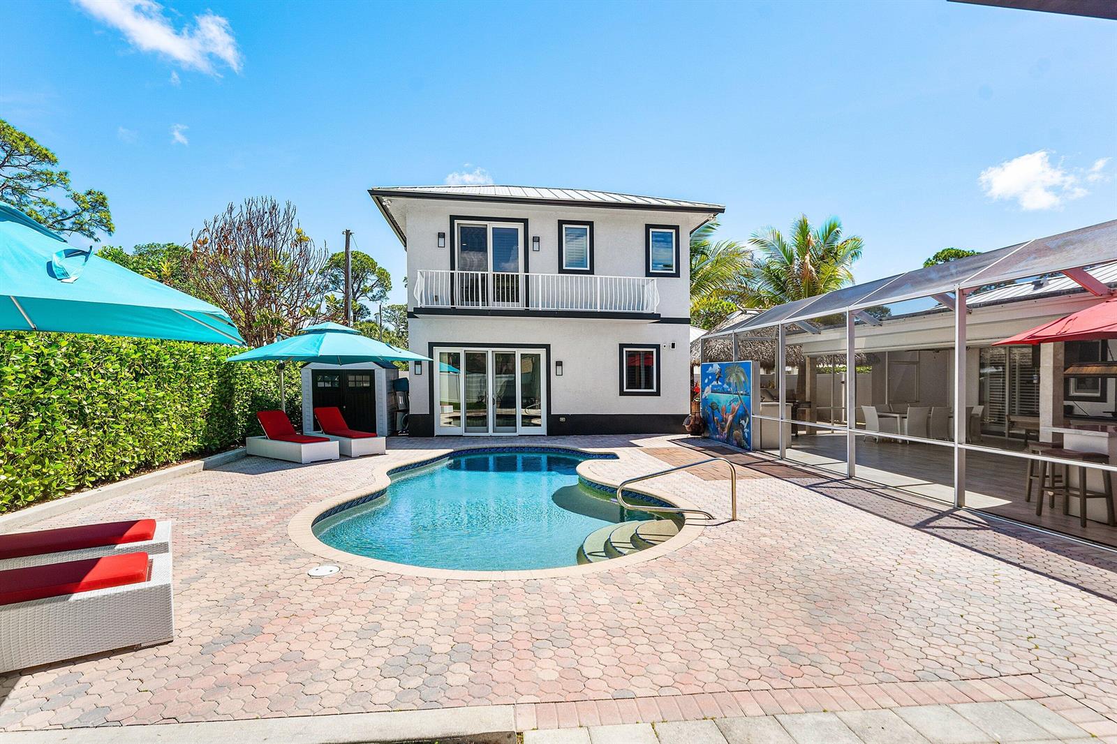 A two-story house with a pool, patio, and screened-in outdoor living area — 5495 Hibiscus Road, Jupiter FL 33458, JUPITER, FL