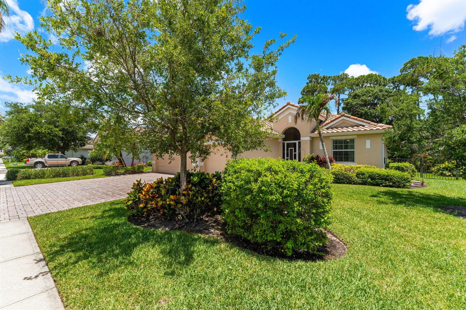 A single-story house with a paved driveway, manicured landscaping, and a tile roof — 7657 Fieldstone Ranch Square, Vero Beach FL 32967, VERO BEACH, FL