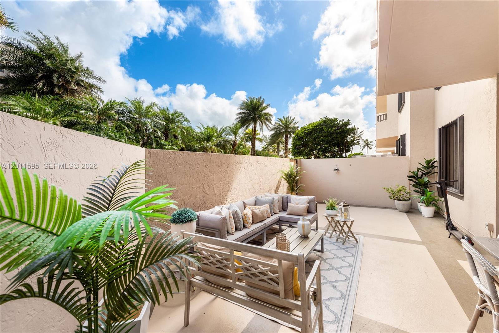 A furnished outdoor patio features a sectional sofa, coffee table, and potted plants — 201 Crandon Blvd # 138, Key Biscayne FL 33149, KEY BISCAYNE, FL