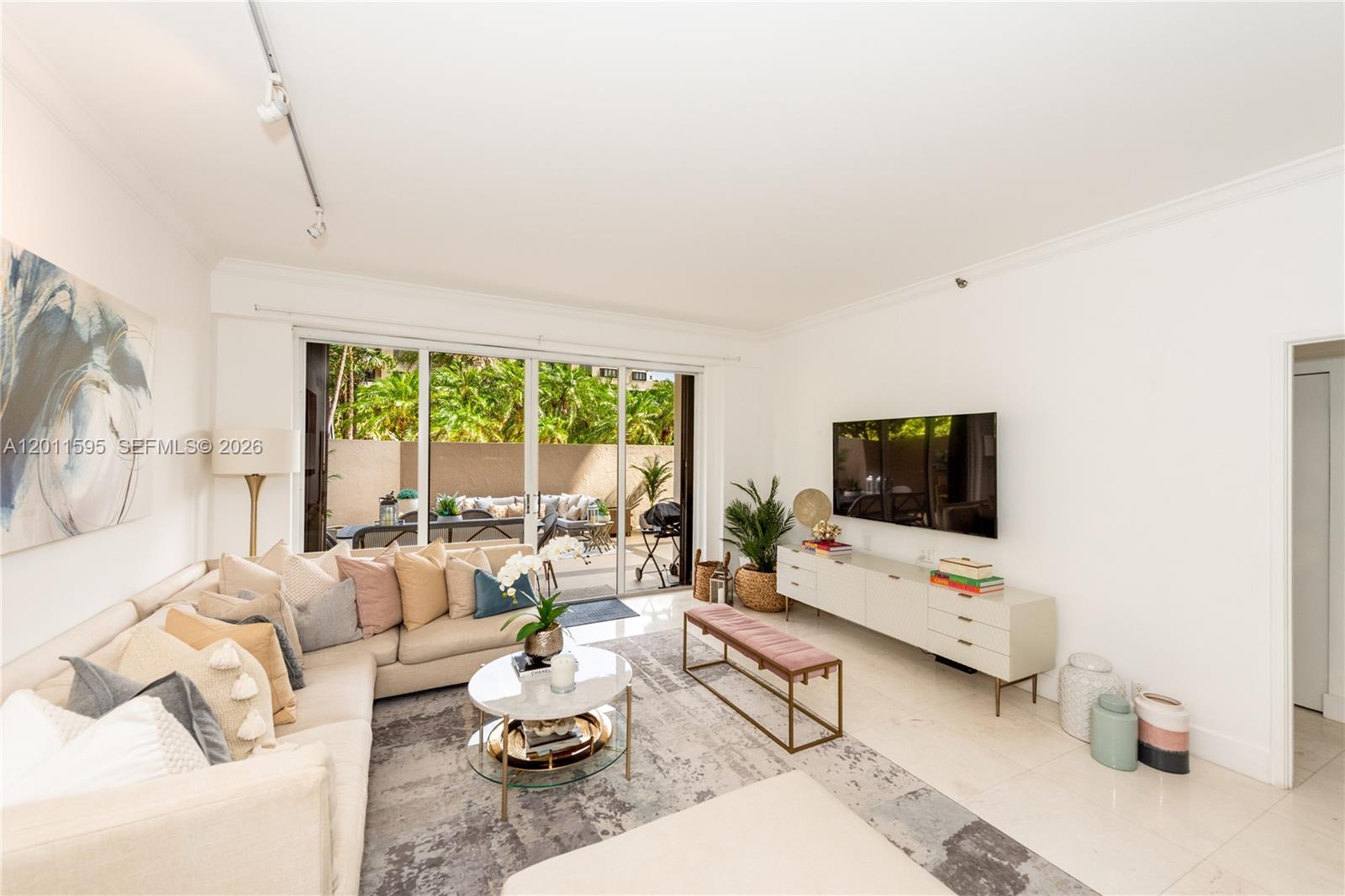 A living room features a sectional sofa, a coffee table, and a wall-mounted television — 201 Crandon Blvd # 138, Key Biscayne FL 33149, KEY BISCAYNE, FL
