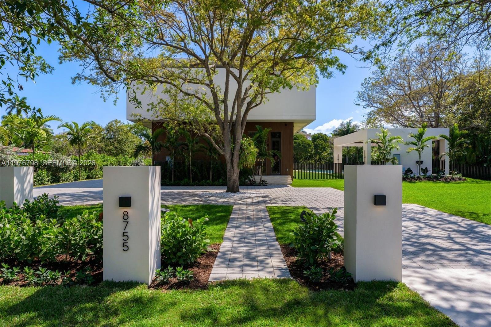 A modern two-story house sits behind a paved driveway and a central walkway — 8755 SW 54th Ave, Miami FL 33143, MIAMI, FL